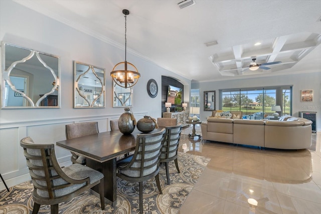 dining room featuring coffered ceiling, crown molding, ceiling fan with notable chandelier, and beamed ceiling