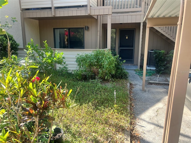 doorway to property with central air condition unit and a balcony