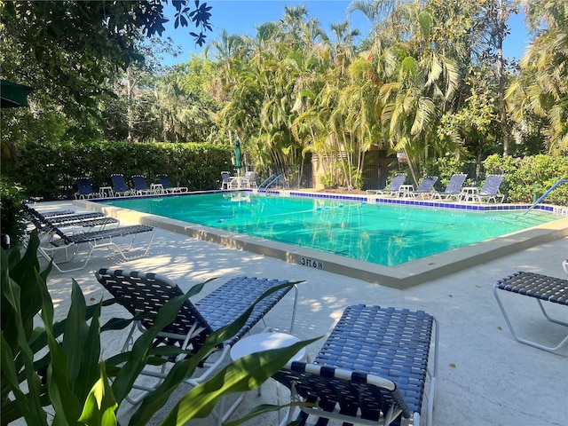 community pool featuring a patio and fence