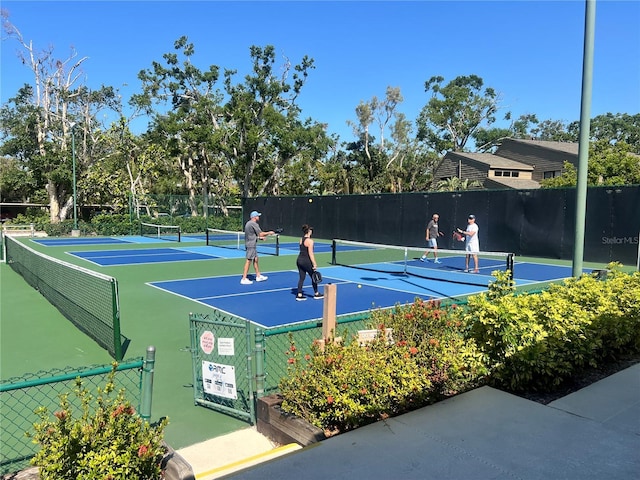 view of tennis court featuring fence