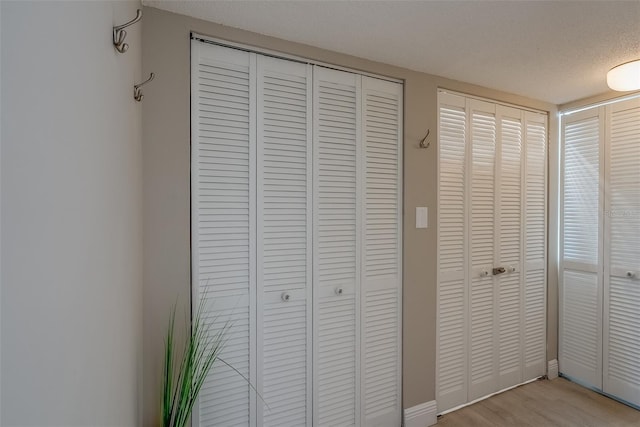 room details featuring a textured ceiling and wood finished floors