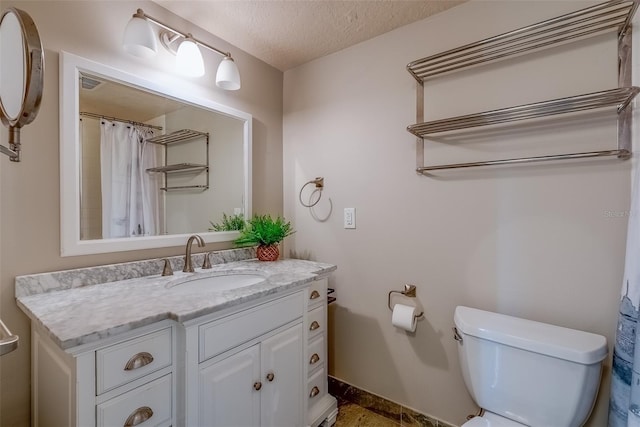 bathroom with visible vents, toilet, a textured ceiling, and vanity