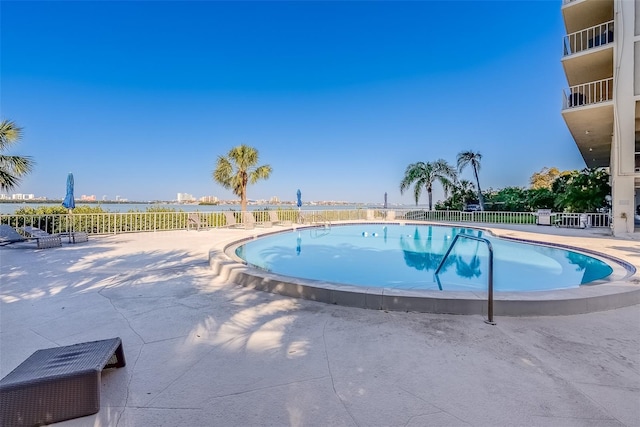 community pool featuring fence and a patio