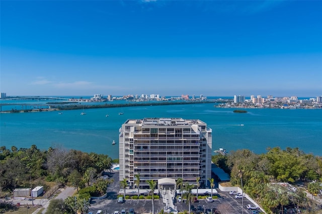 birds eye view of property featuring a water view and a city view