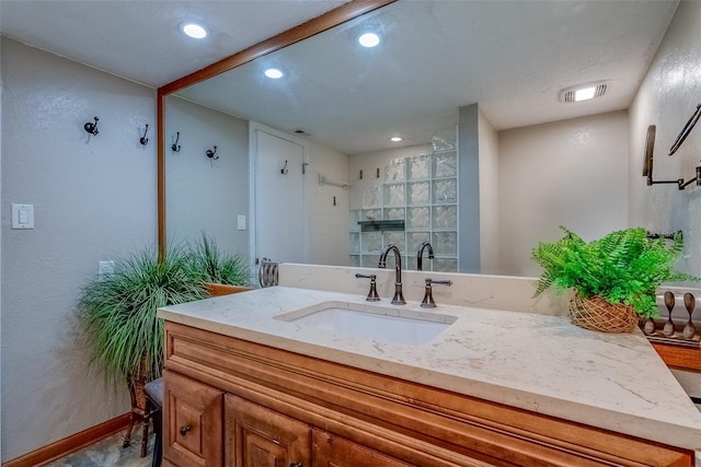 bathroom featuring recessed lighting, visible vents, baseboards, and vanity