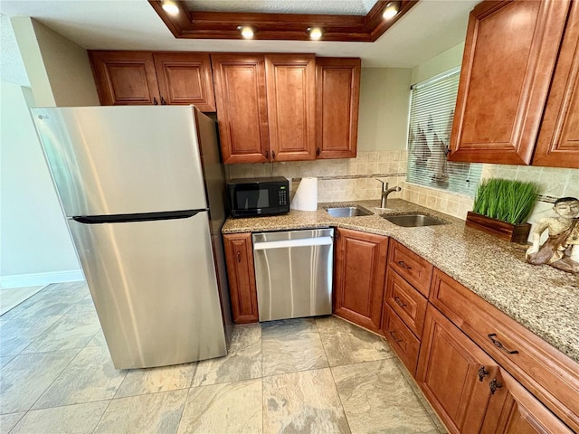 500 N Osceola Ave Unit 203, Clearwater, FL 33755 - kitchen with appliances with stainless steel finishes, brown cabinets, and a raised ceiling