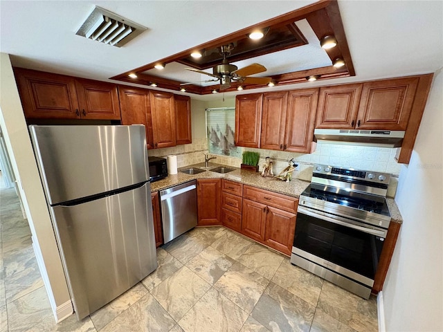 500 N Osceola Ave Unit 203, Clearwater, FL 33755 - kitchen with stainless steel appliances, under cabinet range hood, a raised ceiling, and a sink