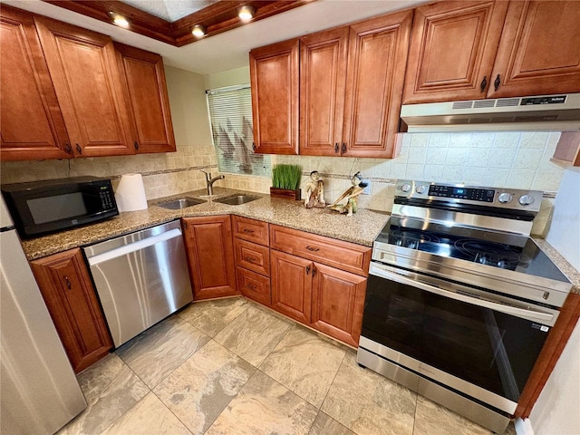 500 N Osceola Ave Unit 203, Clearwater, FL 33755 - kitchen with stainless steel appliances, under cabinet range hood, tasteful backsplash, and brown cabinets