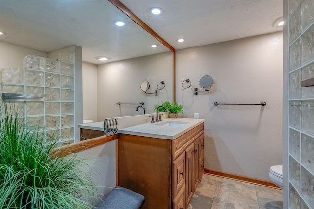 500 N Osceola Ave Unit 203, Clearwater, FL 33755 - bathroom with baseboards, vanity, recessed lighting, toilet, and stone finish floors