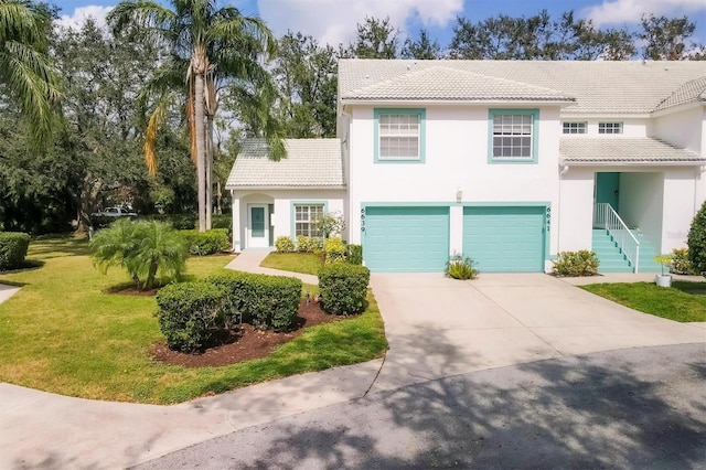 view of front of home featuring a garage and a front yard