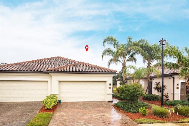 mediterranean / spanish-style home with a garage