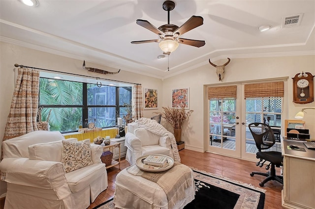 home office featuring visible vents, wood finished floors, vaulted ceiling, french doors, and a healthy amount of sunlight