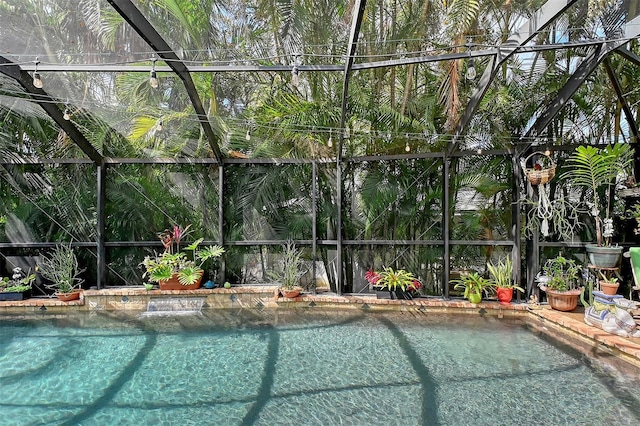 outdoor pool featuring glass enclosure