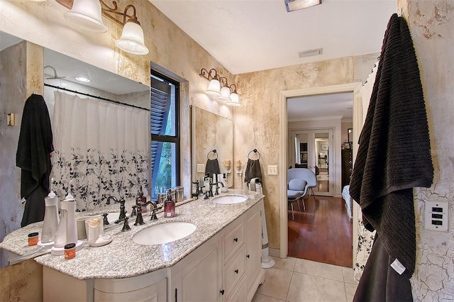 full bath featuring double vanity, visible vents, a sink, and tile patterned floors