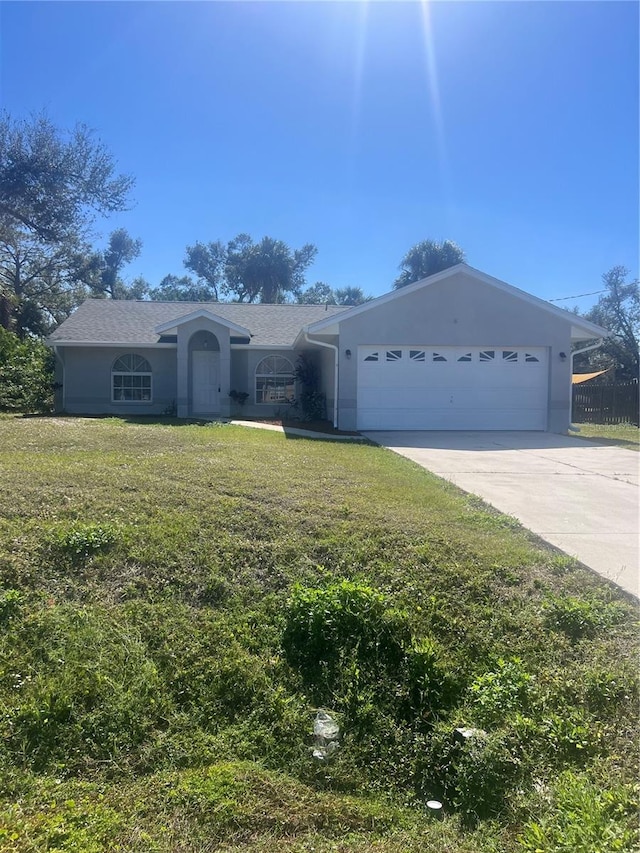 single story home with a front yard and a garage