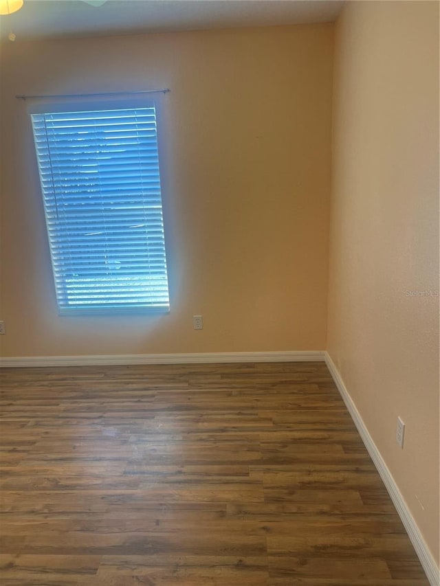 spare room with dark hardwood / wood-style floors