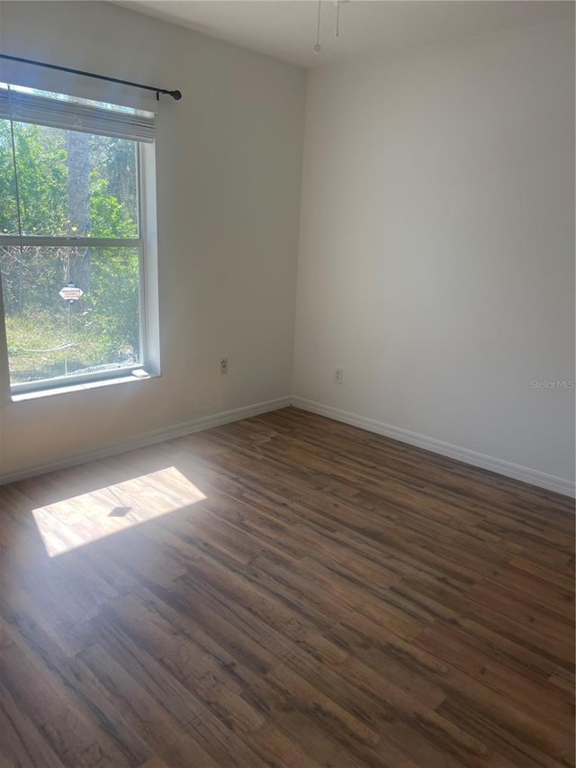 unfurnished room featuring dark hardwood / wood-style floors