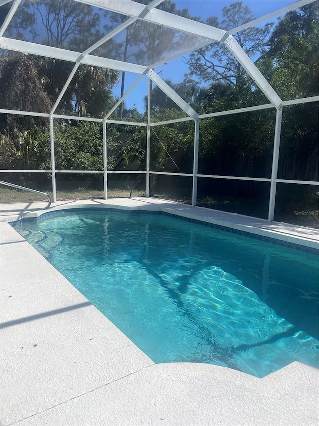 view of swimming pool with a lanai