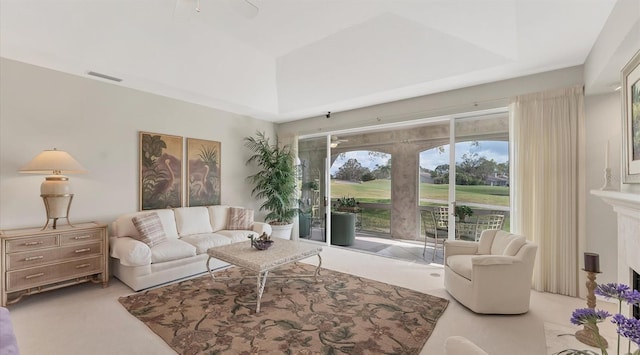 carpeted living room featuring a fireplace