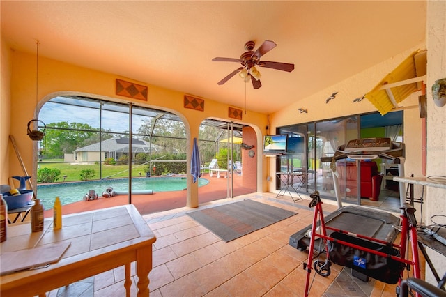 interior space featuring vaulted ceiling, tile patterned floors, and ceiling fan