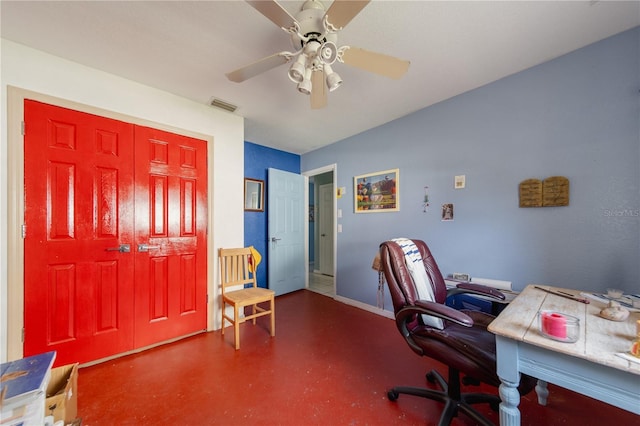 office with ceiling fan and concrete floors