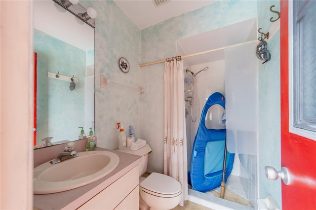 bathroom featuring walk in shower, vanity, and toilet