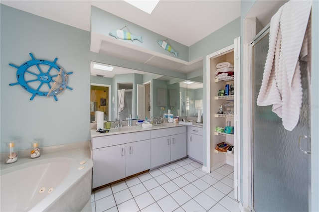 bathroom with vanity, a skylight, tile patterned floors, and shower with separate bathtub