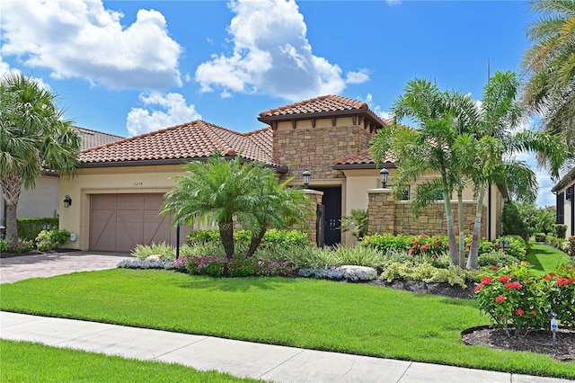 13214 Treviso Dr, Bradenton, FL 34211 - mediterranean / spanish-style home featuring stucco siding, a tiled roof, an attached garage, and stone siding