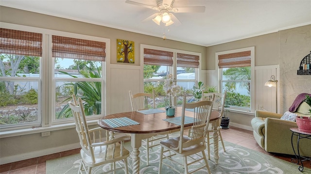 dining space featuring a ceiling fan, light tile patterned flooring, and baseboards