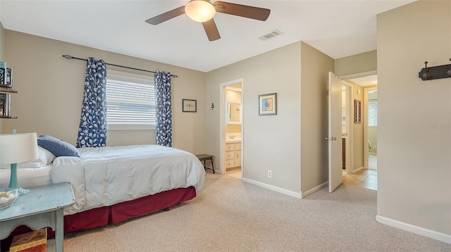 bedroom with light carpet, a ceiling fan, visible vents, and baseboards