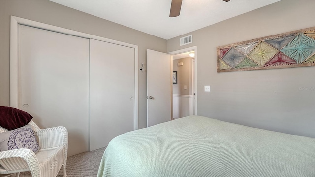 bedroom featuring ceiling fan, visible vents, a closet, and carpet flooring