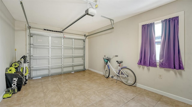 garage with a garage door opener and baseboards