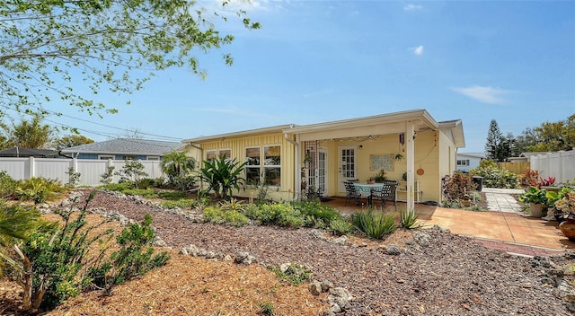 back of house with a patio area and a fenced backyard