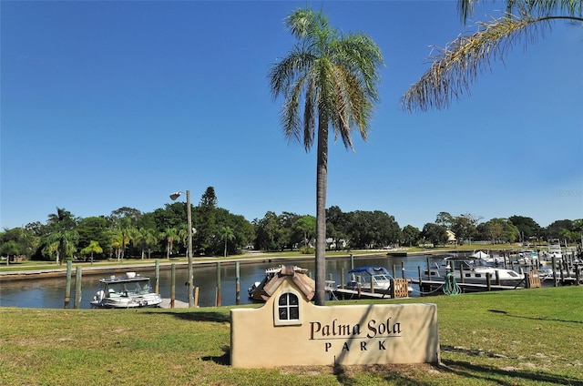 dock area featuring a water view and a yard