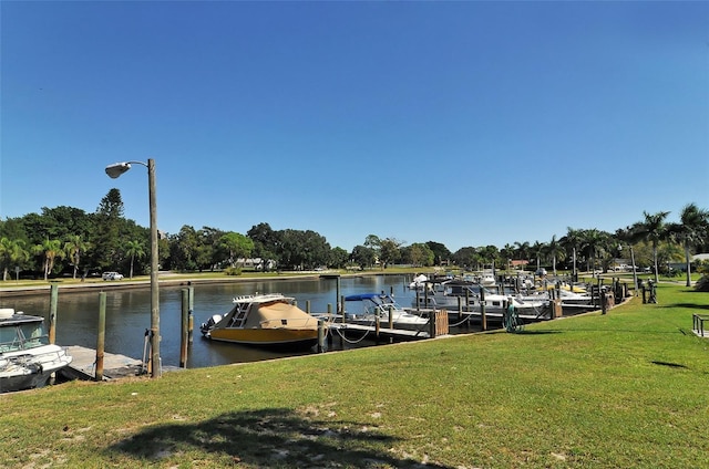 dock area featuring a water view and a lawn