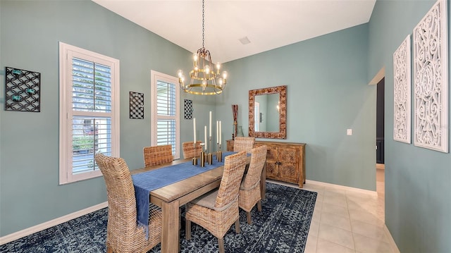 dining room featuring an inviting chandelier, baseboards, and light tile patterned flooring