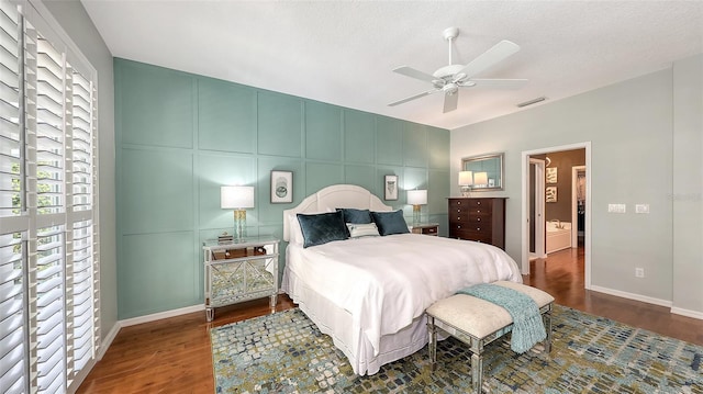 bedroom featuring baseboards, a textured ceiling, visible vents, and wood finished floors