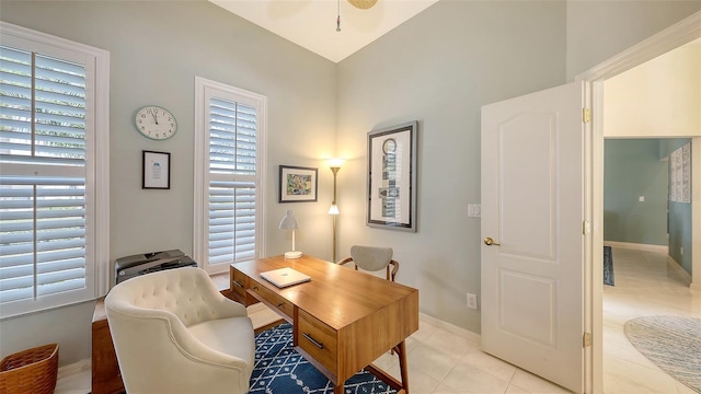 office with baseboards, a wealth of natural light, and light tile patterned flooring