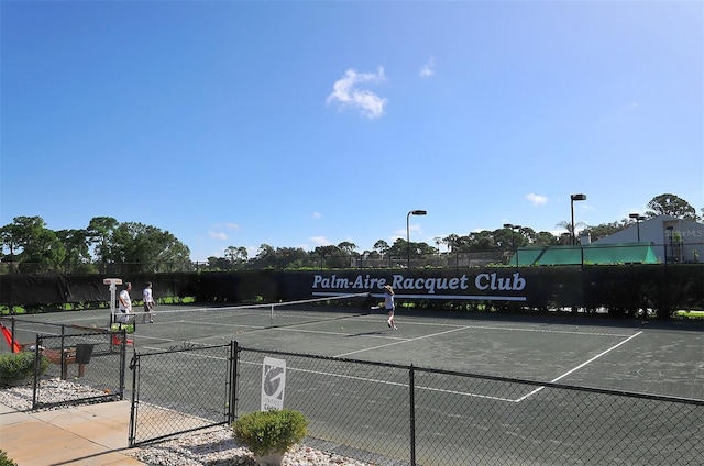 view of sport court featuring fence