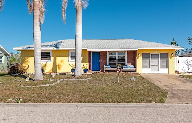 view of front of property with a garage and a front yard