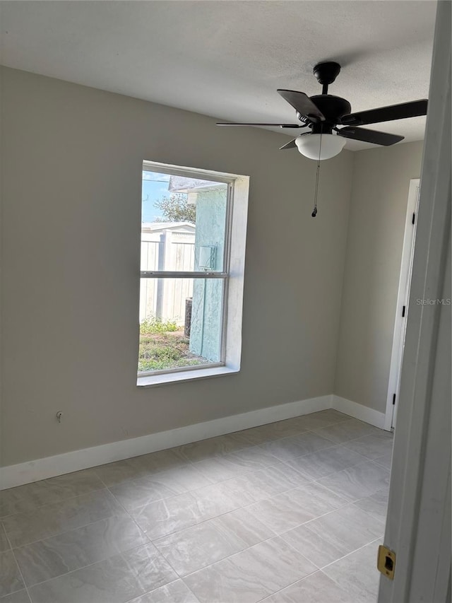 spare room featuring ceiling fan