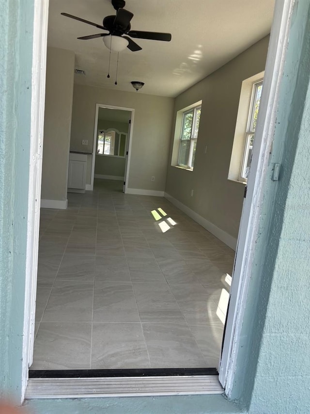 interior space featuring ceiling fan