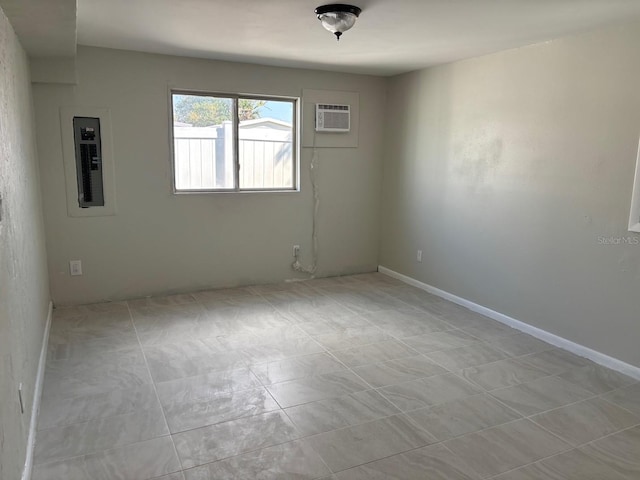 empty room featuring a wall mounted air conditioner and electric panel