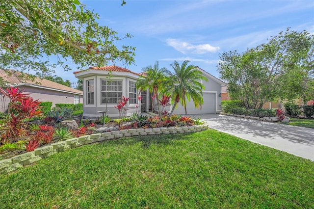 view of front of home featuring driveway, a tile roof, an attached garage, a front yard, and stucco siding