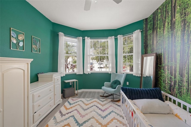 8956 Stone Harbour Loop, Bradenton, FL 34212 - bedroom with baseboards, light wood-style flooring, and ceiling fan
