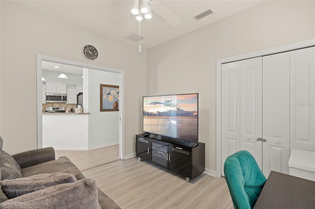 8956 Stone Harbour Loop, Bradenton, FL 34212 - living area featuring visible vents, a ceiling fan, light wood-style flooring, and baseboards