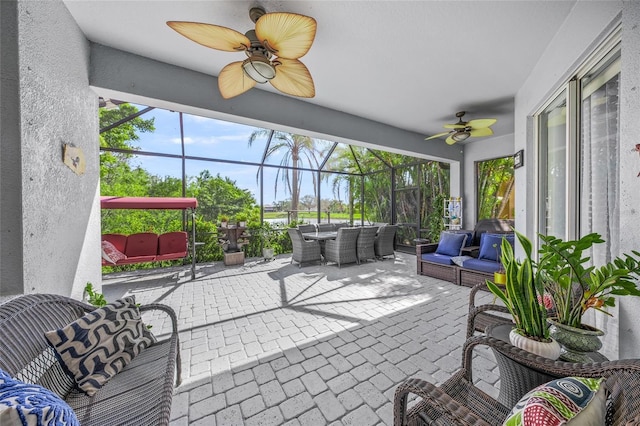 8956 Stone Harbour Loop, Bradenton, FL 34212 - view of patio / terrace featuring outdoor dining area, a ceiling fan, glass enclosure, and outdoor lounge area