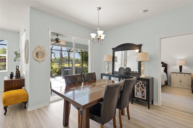 8956 Stone Harbour Loop, Bradenton, FL 34212 - dining area with baseboards, light wood-style flooring, and ceiling fan with notable chandelier