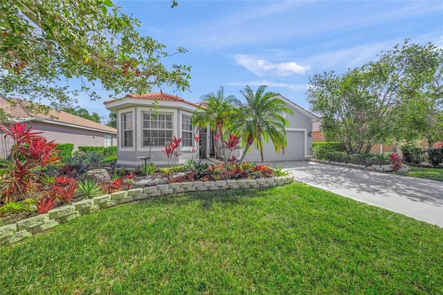 8956 Stone Harbour Loop, Bradenton, FL 34212 - view of front of house with driveway, a tile roof, a garage, a front lawn, and stucco siding