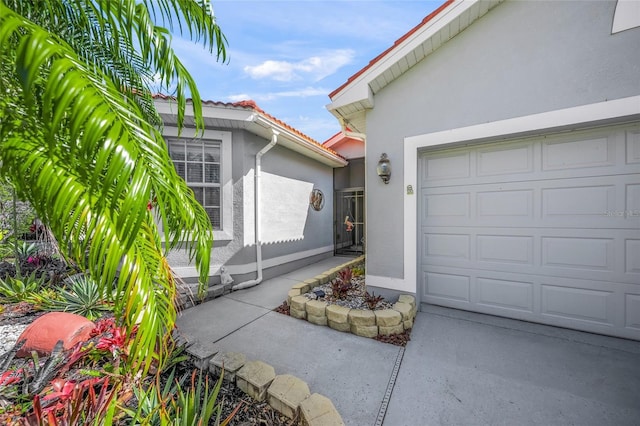 8956 Stone Harbour Loop, Bradenton, FL 34212 - exterior space with an attached garage and stucco siding